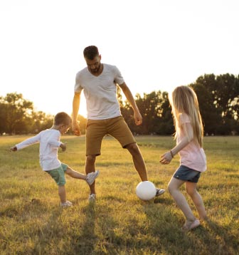 Dad and kids playing soccer